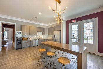 A kitchen with a bar stool and a counter.